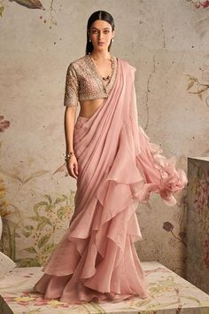 Dusky pink pre-draped saree with ruffle border. Paired with sequin, bead, cutdana half sleeve net embroidered blouse.
Components: 2
Pattern: Embroidery
Type Of Work: Sequin, bead, cutdana
Neckline: Plunge V neck
Sleeve Type: Half sleeves
Fabric: Saree: Chiffon, Organza, Blouse: Net
Color: Pink
Other Details: 
Back cut-out blouse
Occasion: Reception - Aza Fashions Black Net Blouse, Ridhi Mehra, Saree Wearing Styles, Saree Wearing, Net Blouses, Organza Blouse, Ruffle Saree, Embroidered Crop Tops, Drape Saree