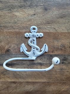 an anchor and hook on a wooden surface