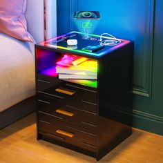 a night stand with three drawers and a projector light on the top one drawer