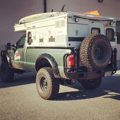 an off road vehicle parked in front of a building