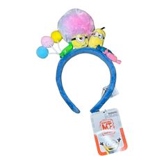 a blue headband with two small yellow birds on it's side and balloons attached to the top