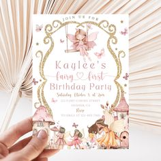 a hand holding up a birthday party card with fairy characters on the front and back