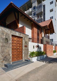 an apartment building with two garages on the side