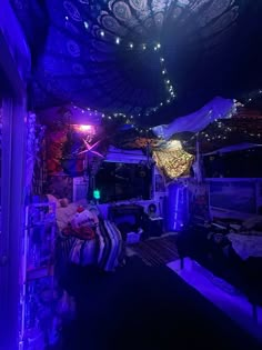 the inside of a room with lights and decorations on the ceiling is lit up at night