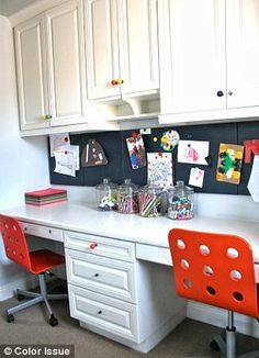 a white desk topped with two red chairs and lots of magnets on the wall