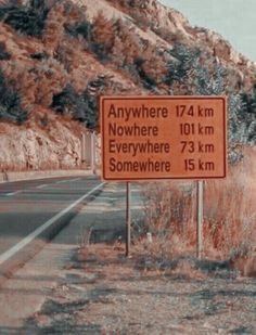 there is a sign on the side of the road that says anywhere 124 km nowhere