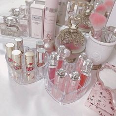 the vanity is filled with many different types of perfumes and other personal care products