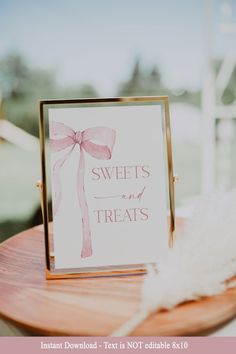 there is a sign that says sweets and treats on the table with feathers around it