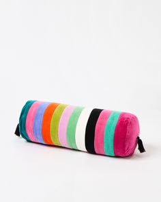 a multicolored striped pillow on a white background