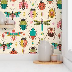 the wallpaper is colorful and has many bugs on it