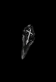 a diamond ring with a cross in the middle on a black background that appears to be dark