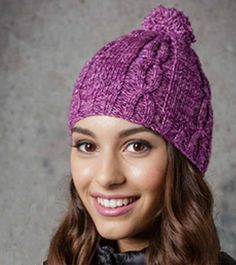 a woman wearing a purple knitted hat