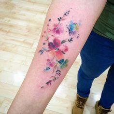 a person with a flower tattoo on their arm