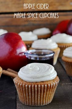 apple cider maple spice cupcakes on a wooden table with apples in the background