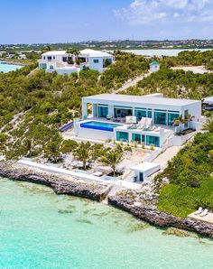 an aerial view of a house on the water