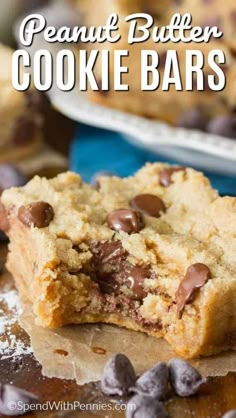 peanut butter cookie bars stacked on top of each other with chocolate chips around the edges