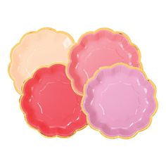 three pink and yellow plates sitting next to each other