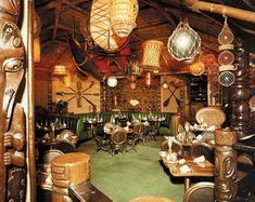 the inside of a restaurant with wooden tables and chairs, lights hanging from the ceiling