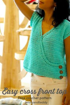 a woman is wearing a green crochet top and white pants with her hands on her head