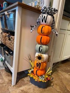 a stack of pumpkins sitting on top of a kitchen counter