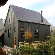 a house with a metal roof and wooden steps