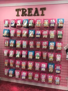 there is a pink wall with lots of tea bags on it and the words treat written in large letters