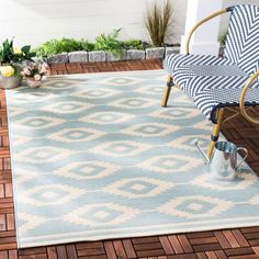 a blue and white area rug on a patio