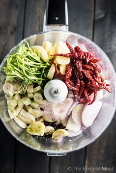 an overhead view of vegetables in a food processor