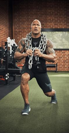 a man with chains around his neck in a gym