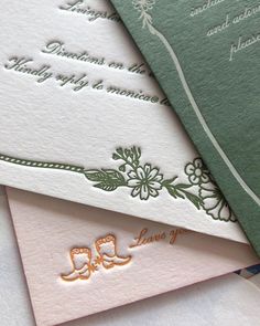 three different colored wedding cards on top of each other