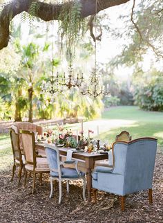 a dining table with chairs and a chandelier