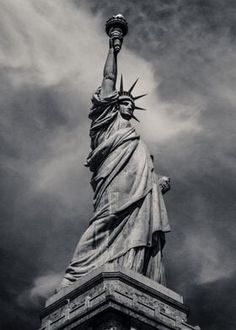 the statue of liberty under a cloudy sky