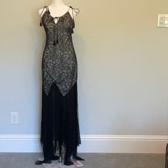 Sleek Black Haute Hippy Maxi Gown. Sleeveless. Floor Length. Fully Lined. Hidden Back Zipper. Nylon. Brand New. Never Worn. Pristine Condition. Measurements Are Laid Flat: Chest: 15 Waist: 14 Hip: 16 Lenght: 64 Refer To Photo’s For Details As Part Of Description. Smoke Free Home Lace Bias-cut Maxi Dress For Evening, Fitted Sleeveless Flapper Dress For Gala, Sleeveless Black Lace Gown, Glamorous Sleeveless Lace Evening Dress, Elegant Floor-length Flapper Evening Dress, Elegant Floor-length Flapper Dress, Elegant Formal Floor-length Flapper Dress, Black Sleeveless Cocktail Gown, Black Lace Dress With Bias Cut