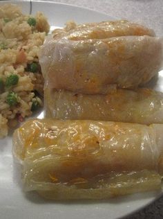 some food is sitting on a plate with rice and broccoli next to it