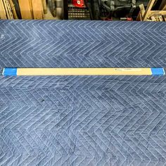 a baseball bat laying on top of a blue quilt