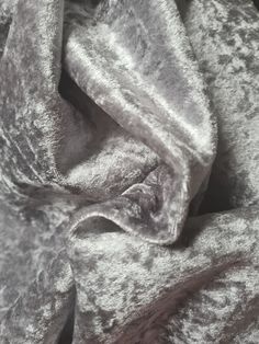 an up close shot of a silver crushed velvet fabric