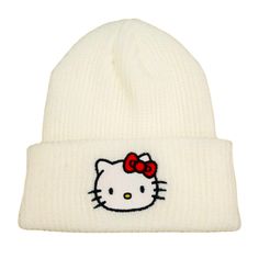 a white hello kitty beanie hat with a red bow on the front and side