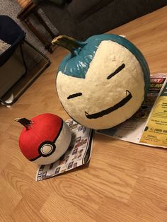 a pokemon pumpkin sitting on top of a wooden table