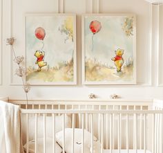 two paintings on the wall above a crib in a baby's nursery room