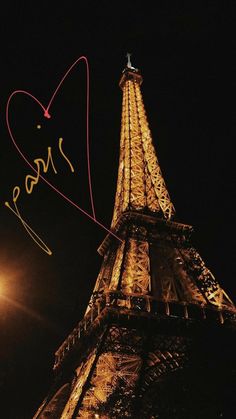 the eiffel tower is lit up at night and has writing on it that says love