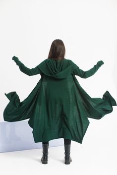 "This asymmetrical and modern cloak with hood has two side pockets, a super comfy hood, and thumb holes for a fabulous look. The model in the picture is 170cm. ⅼ 5.7 ft. tall and is wearing size XS/color: emerald green 🌟 INFO: * Worldwide EXPRESS shipping - please provide a phone number for shipping documents * US Sizing XS to 4XL - size chart available below - all measurements of the body * We offer customization to Personal Measurements & Larger Sizes 5XL, 6XL, and 7XL .... 🌟 MATERIAL & CARE Long Hooded Cloak, Cloak With Hood, Cyberpunk Cosplay, Wool Cloak, Long Cloak, Winter Cloak, Green Wool Coat, Wool Cape, Hooded Cloak