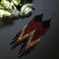 "These red gold and black long fringe bead earrings pair amazingly with any outfit, dressy or casual. They are made of high-quality Czech colored beads with steel . Colors: red gold and black Length: 6 inches (15,5 cm) Width: 1 inches (2.5 cm) Materials: Czech \"Preciosa\" beads Durable synthetic thread" Black And Red Beaded Earrings, Red Beaded Tassel Earrings For Party, Red And Black Beaded Earrings For Festival, Red And Black Beaded Festival Earrings, Black Beaded Fringe Tassel Earrings For Festival, Black Beaded Tassel Earrings For Festivals, Black Beaded Fringe Earrings For Party, Party Black Beaded Fringe Earrings, Black Beaded Fringe Tassel Earrings For Party