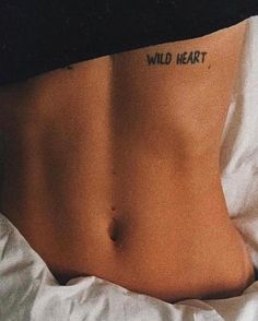 a woman's stomach with the words wild heart written on it