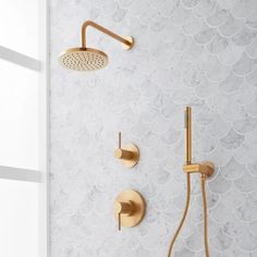 a gold shower faucet with thermostaer and hand shower head