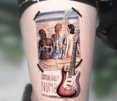 a woman's thigh with an image of two women and a guitar on it