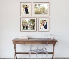 a table with pictures hanging on the wall above it and a chair in front of it