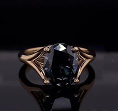 a black diamond ring sitting on top of a table