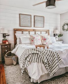 a bed with white sheets and pillows in a room