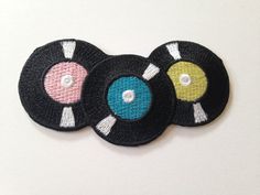 three black and white patches with colorful circles on them