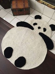 two panda bear rugs sitting on top of a wooden floor